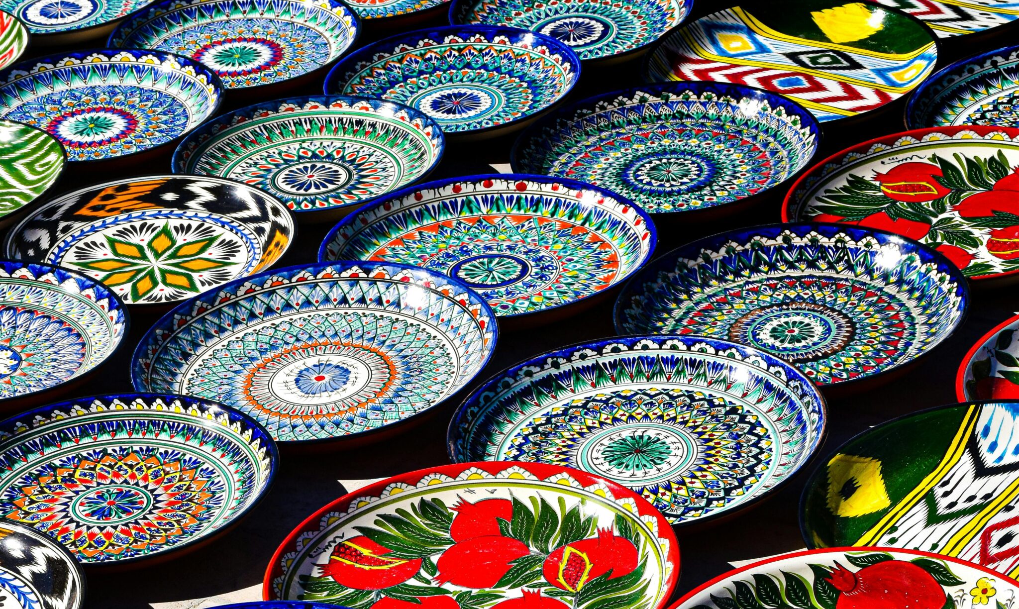Vibrant hand-painted Uzbek ceramic plates showcasing traditional patterns in Bukhara, Uzbekistan.