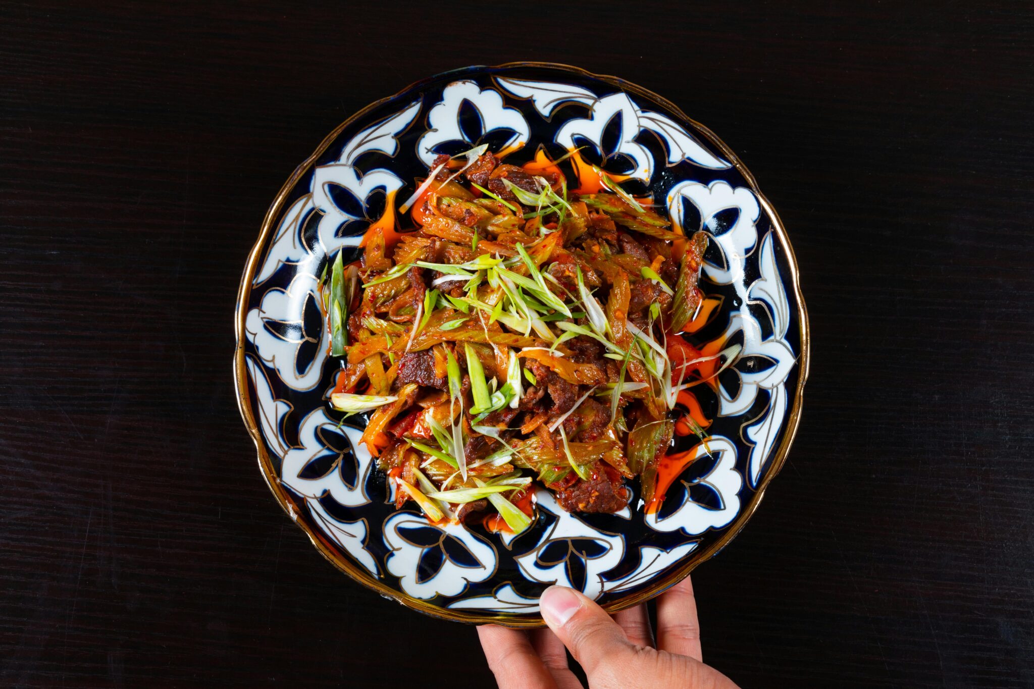 Vibrant beef stir-fry with vegetables, beautifully served on an ornate plate, capturing culinary artistry.