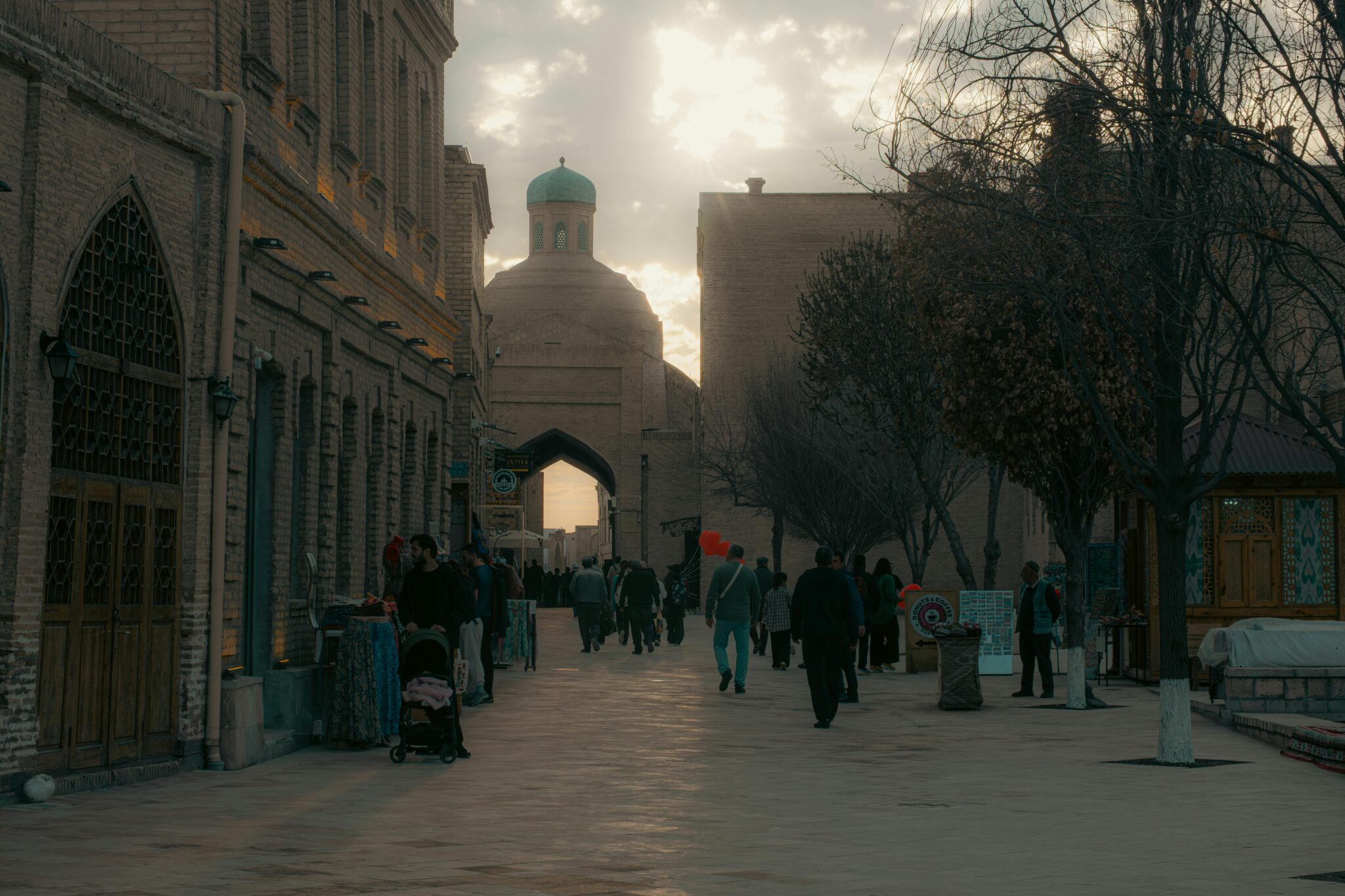 A serene evening in the historic city of Bukhara, Uzbekistan, showcasing classic architecture and daily life.
